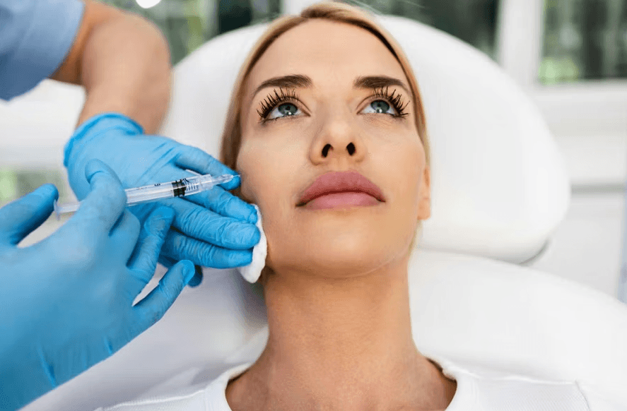 Woman receiving a facial injection from a practitioner.